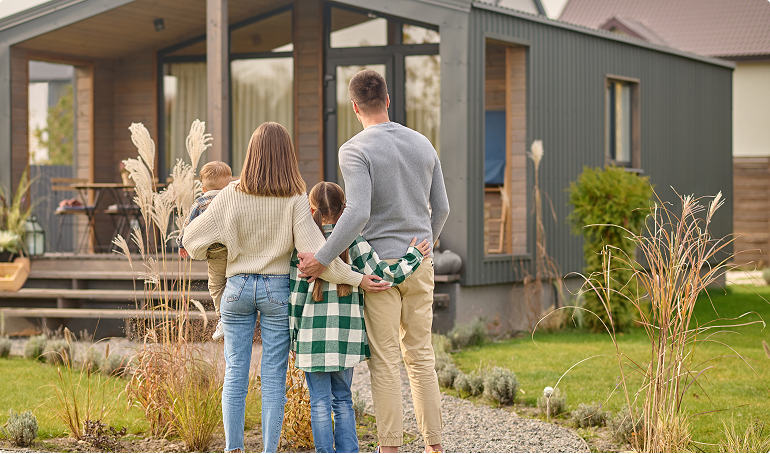 Family in front of their new home